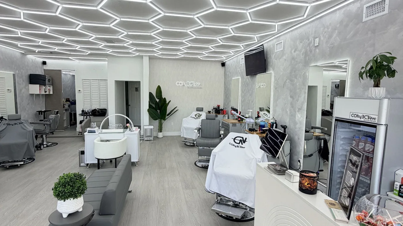 Inside Connection Barbershop: bright mirrors, barber stations, and geometric ceiling lights